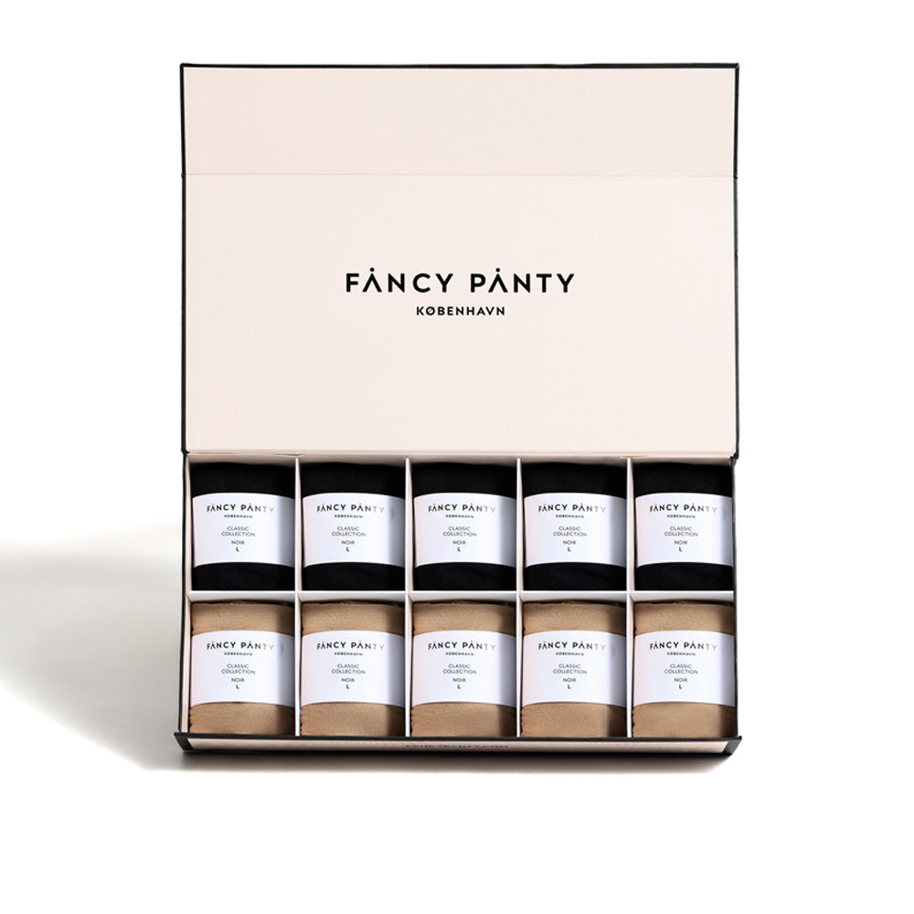 Die Classic Box von Fancy Panty Copenhagen präsentiert eine sorgfältig zusammengestellte Kollektion von Strumpfwaren, darunter Strumpfhosen und Kniestrümpfe in verschiedenen Farbtönen, elegant verpackt und reisefertig.